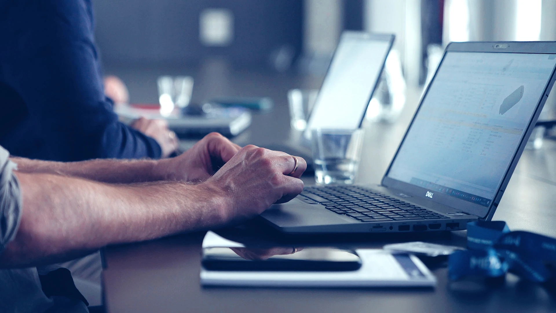 Close-up of hands of two people sitting at a laptop and dealing with data at MEYLE.