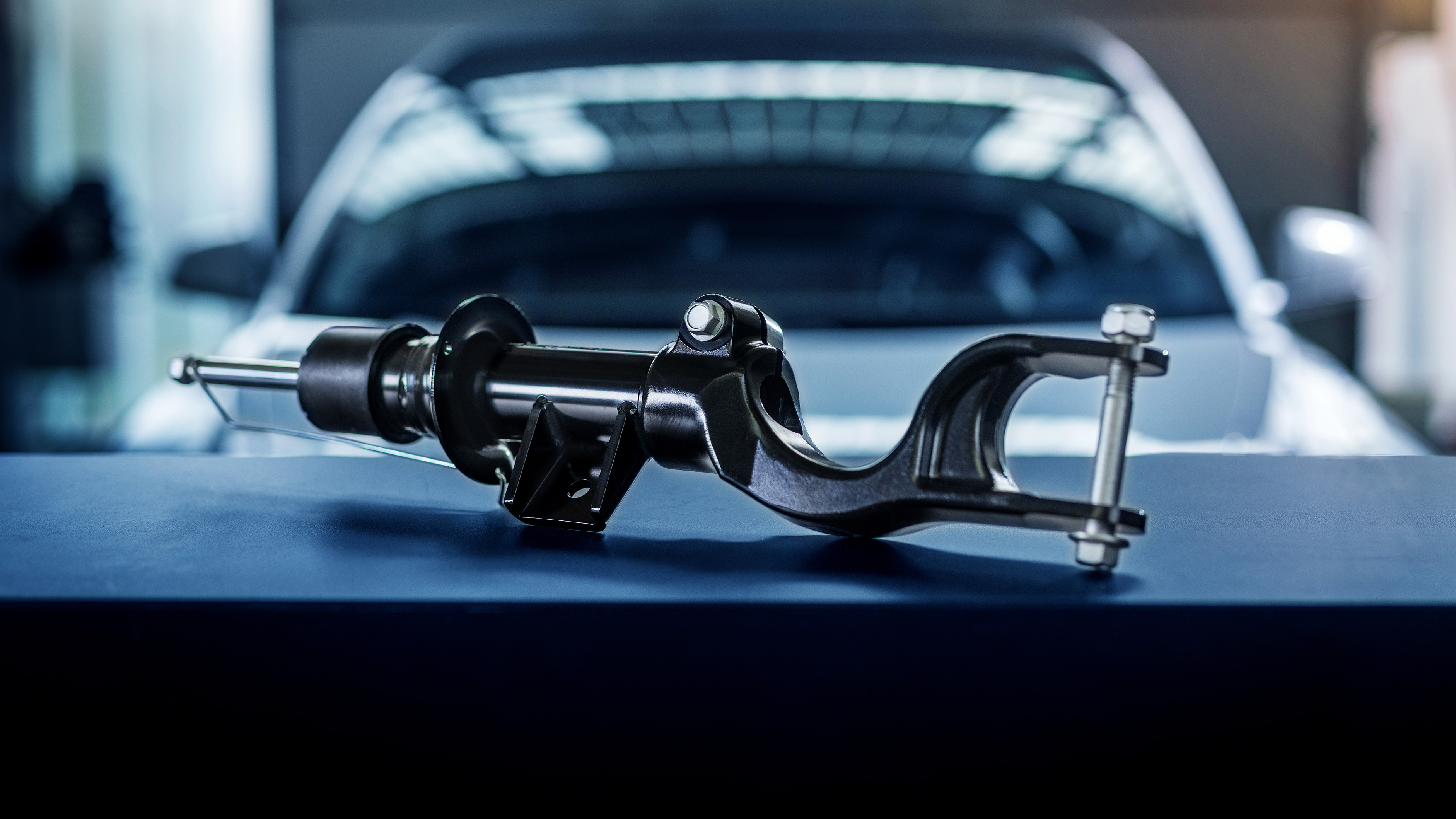 Photo of the MEYLE PD shock absorber for the Tesla Model 3 and Y in a workshop setting.