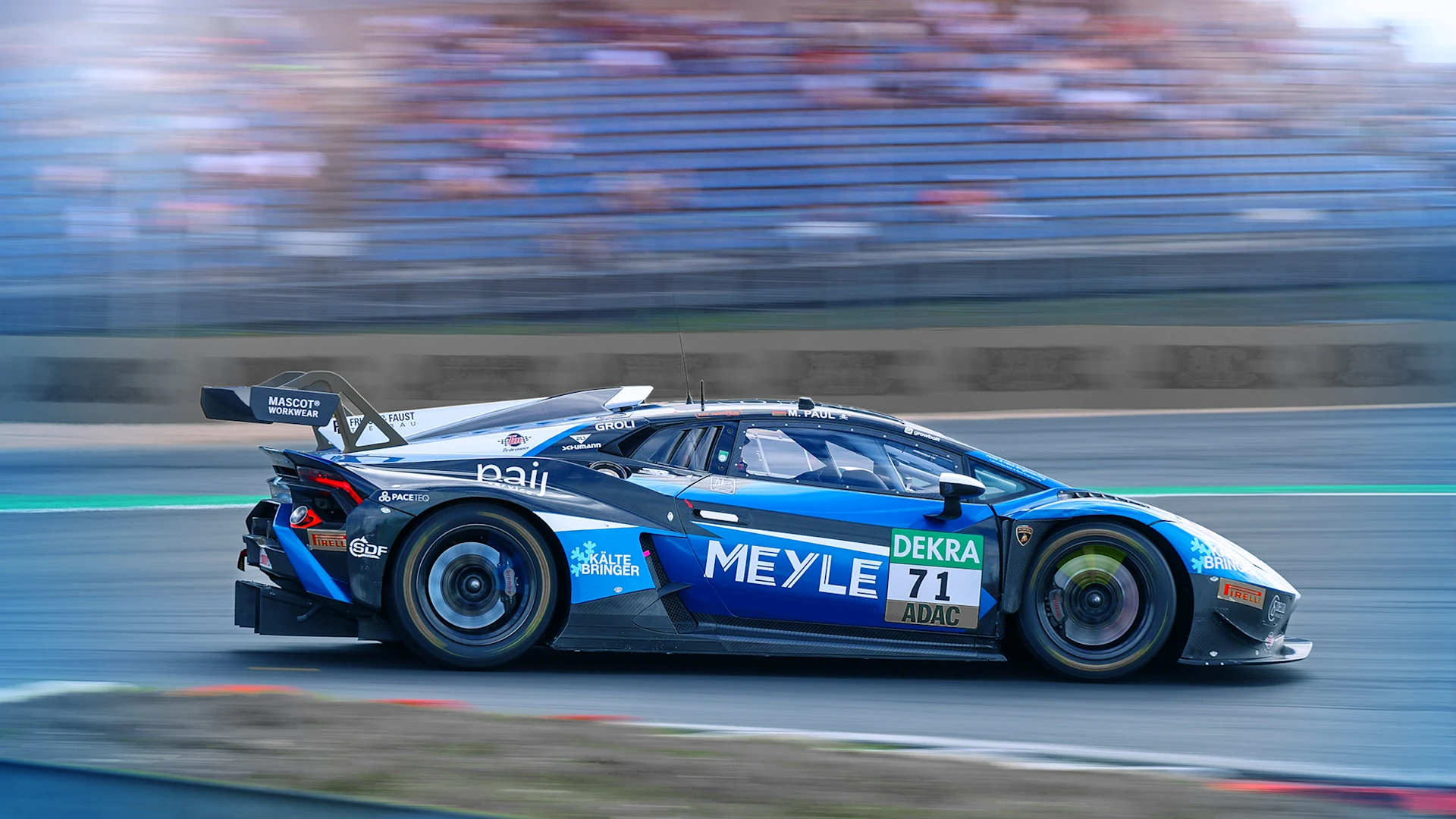 Lamborghini with MEYLE logo drives around a bend, the background is blurred.