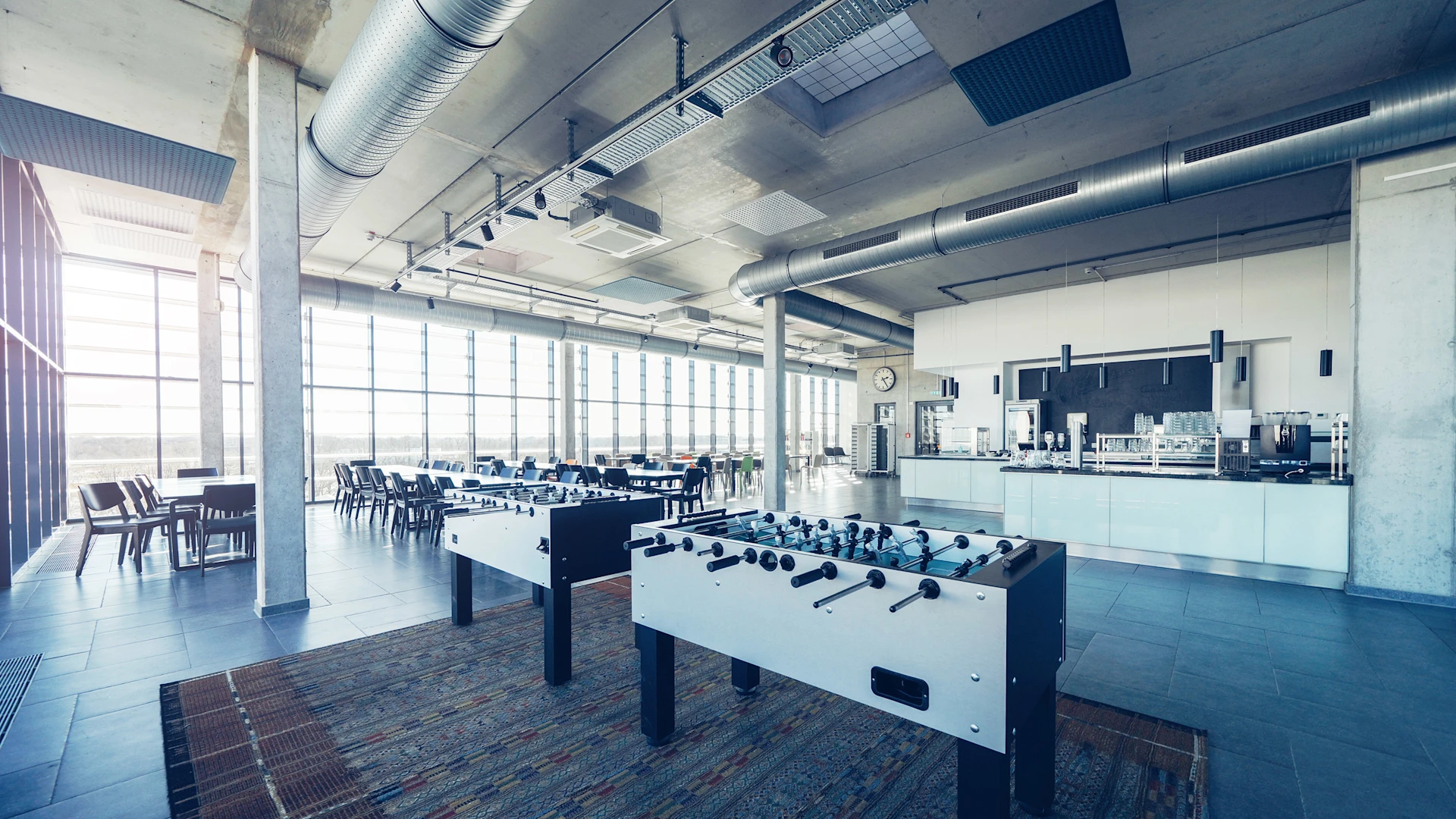Image of the MEYLE company restaurant with an industrial look, with foosball tables in the foreground.