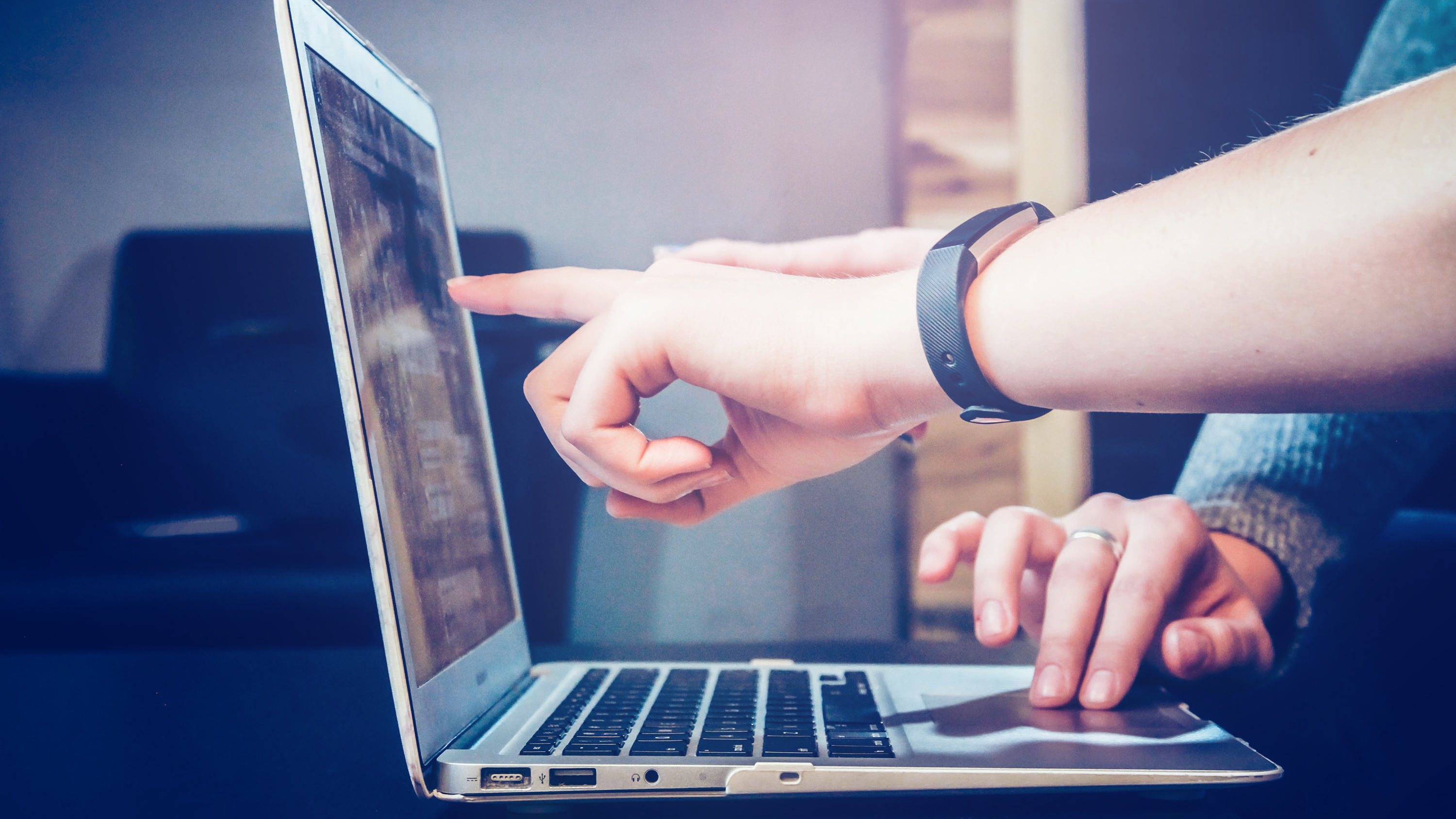 Finger points to a screen.