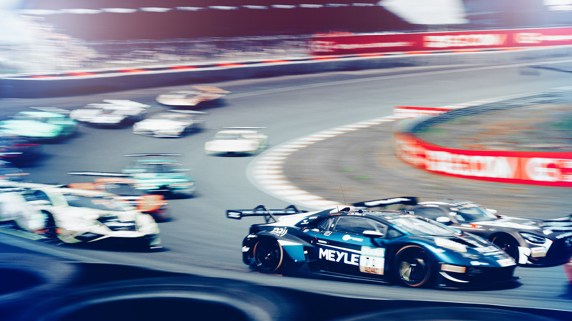 Car race with a branded Lamborghini with MEYLE logo. Many other racing cars can be seen in the motion blur.