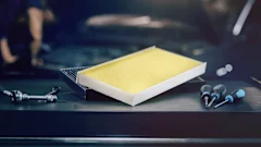 Photo of a MEYLE cabin air filter lying on a tool trolley with tools.