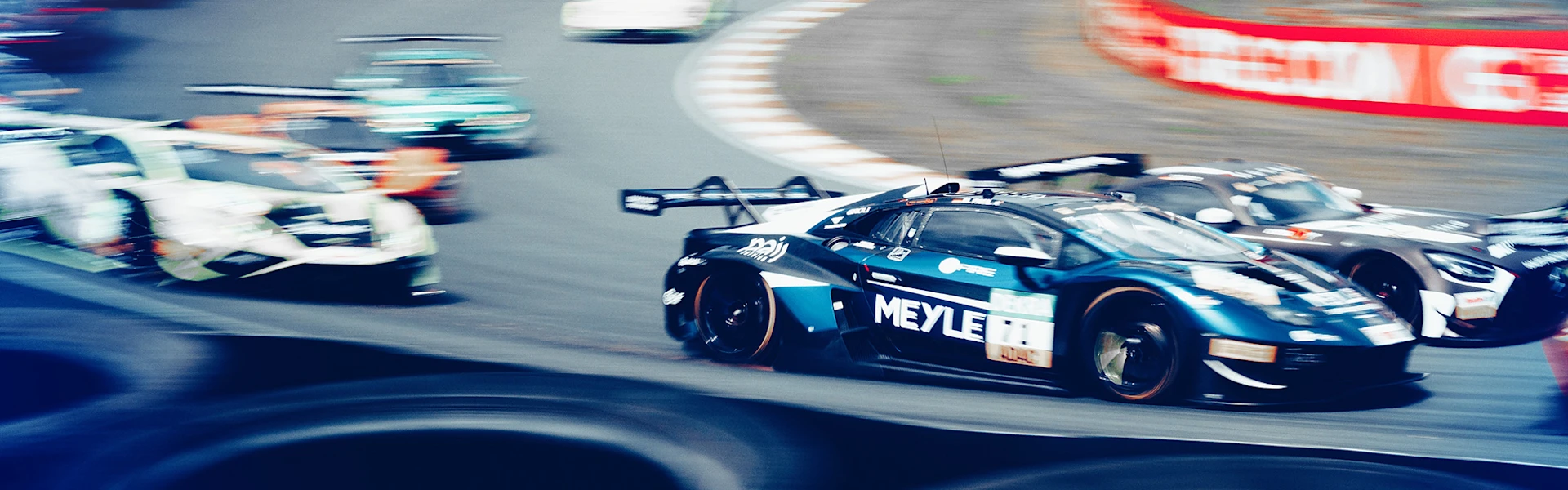 Car race with a branded Lamborghini with MEYLE logo. Many other racing cars can be seen in the motion blur.