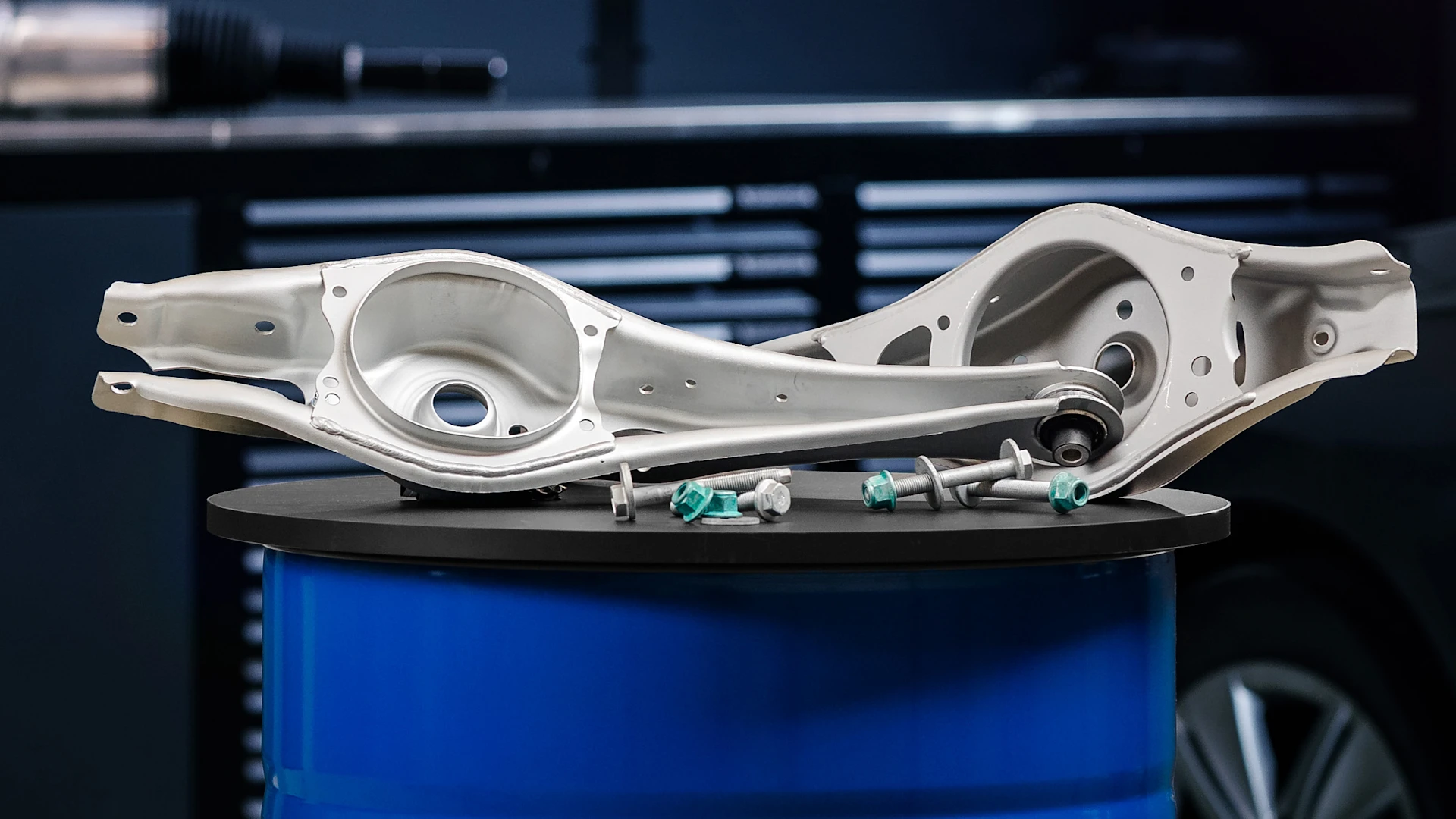 Photo of two MEYLE rear axle control arms for Golf 7 and 6 in a workshop environment.