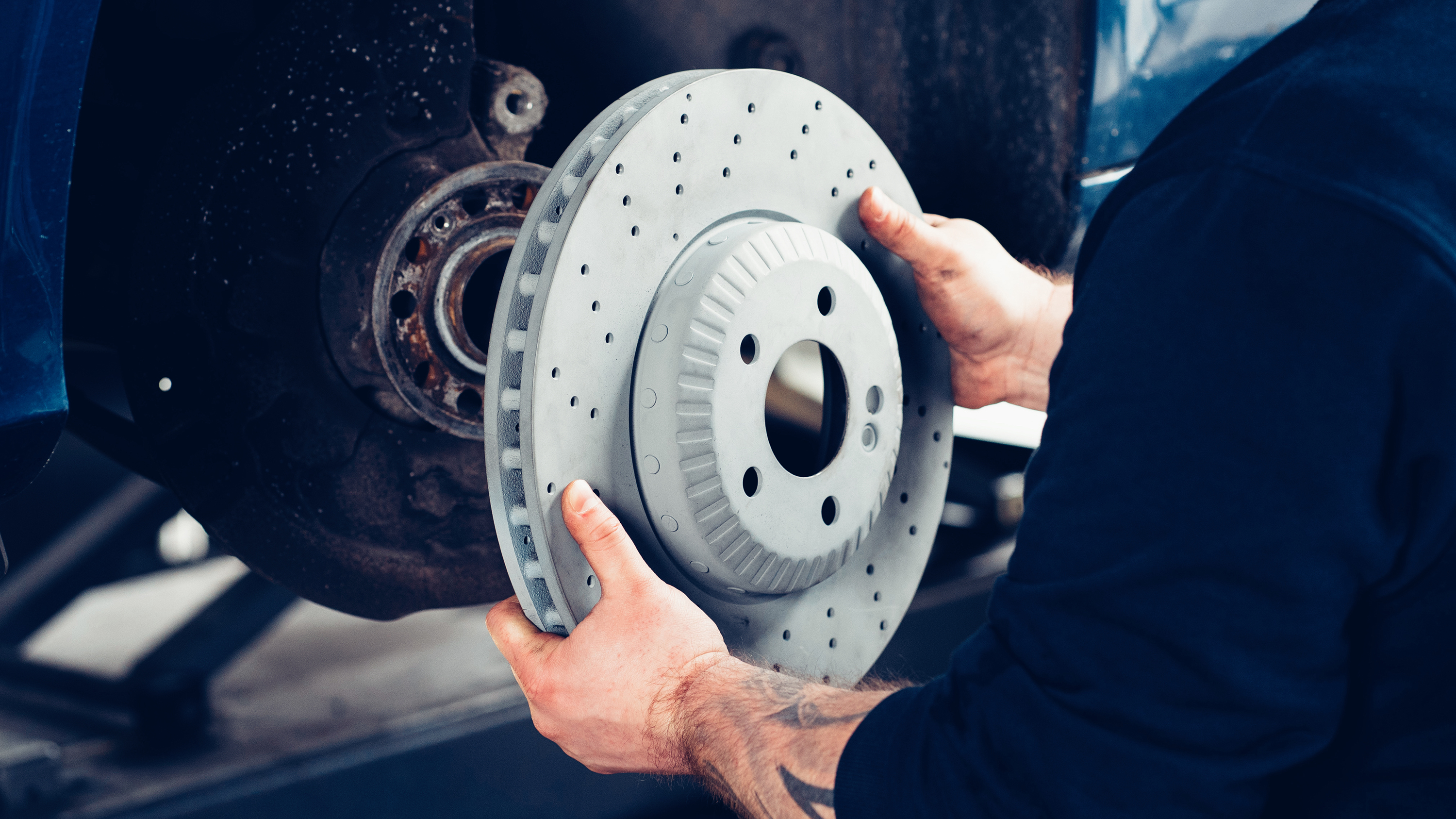 Picture of the 2-piece brake disk that a mechanic is about to install.