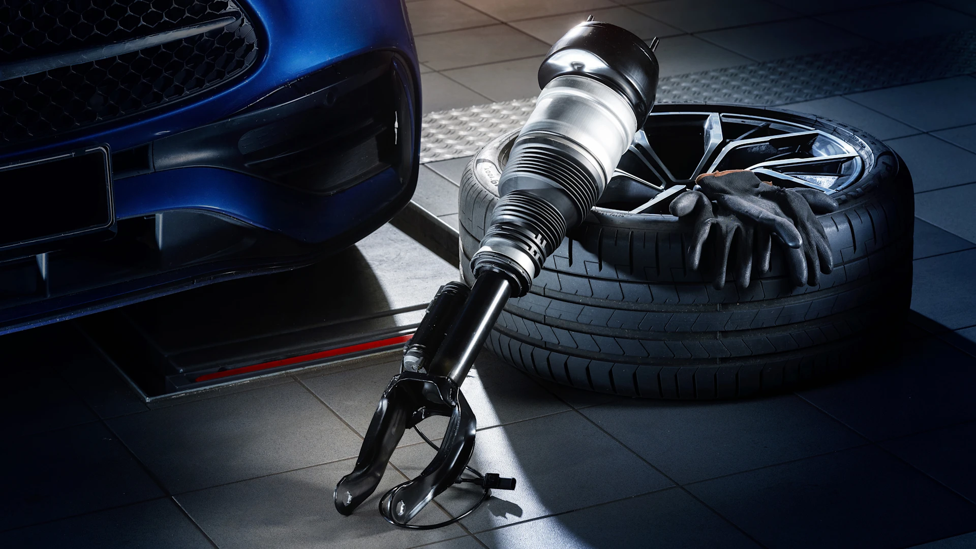 Photo of air suspension strut in a workshop environment.